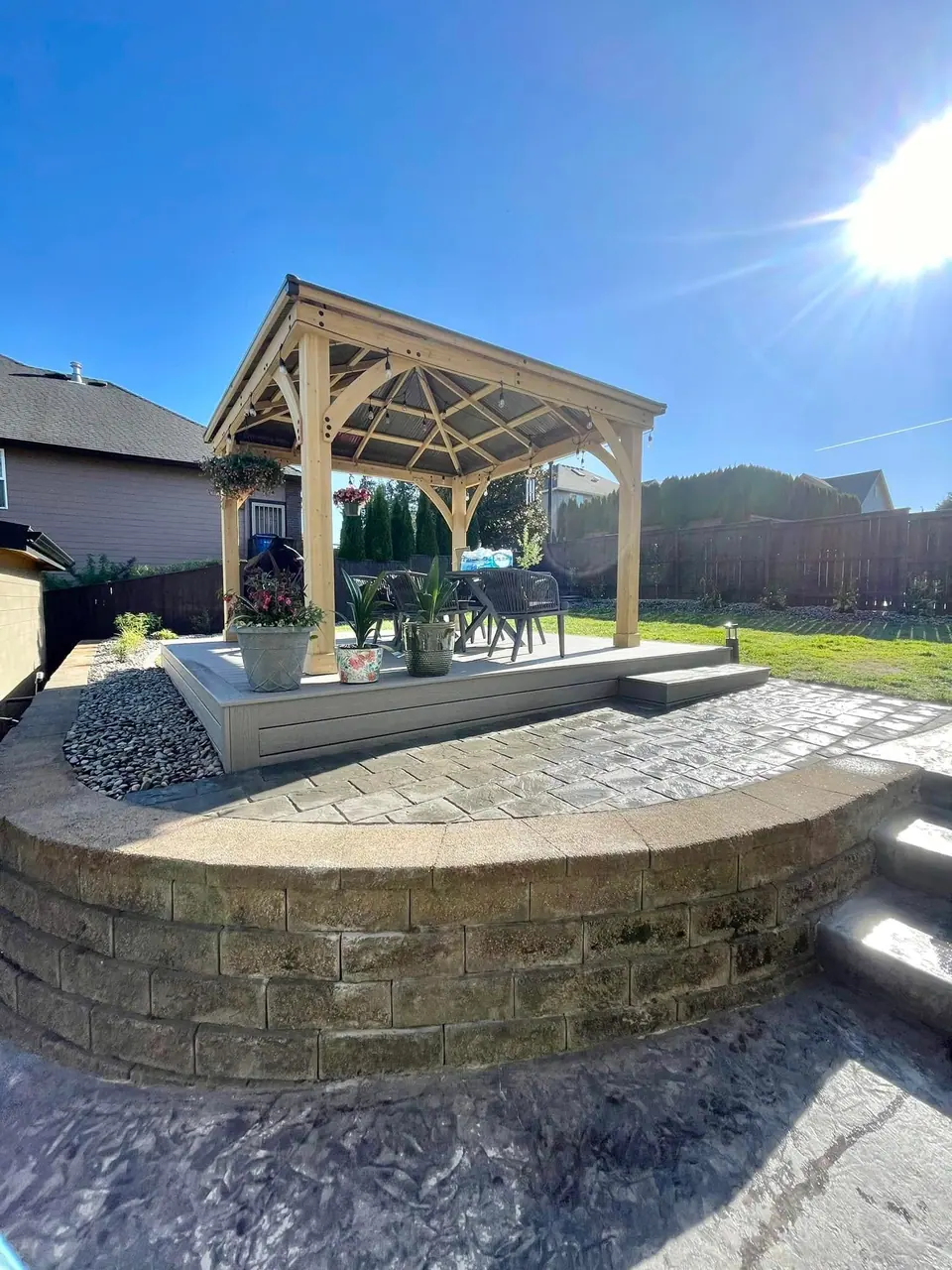 Cedar pergola over a paver patio with a curved seat wall