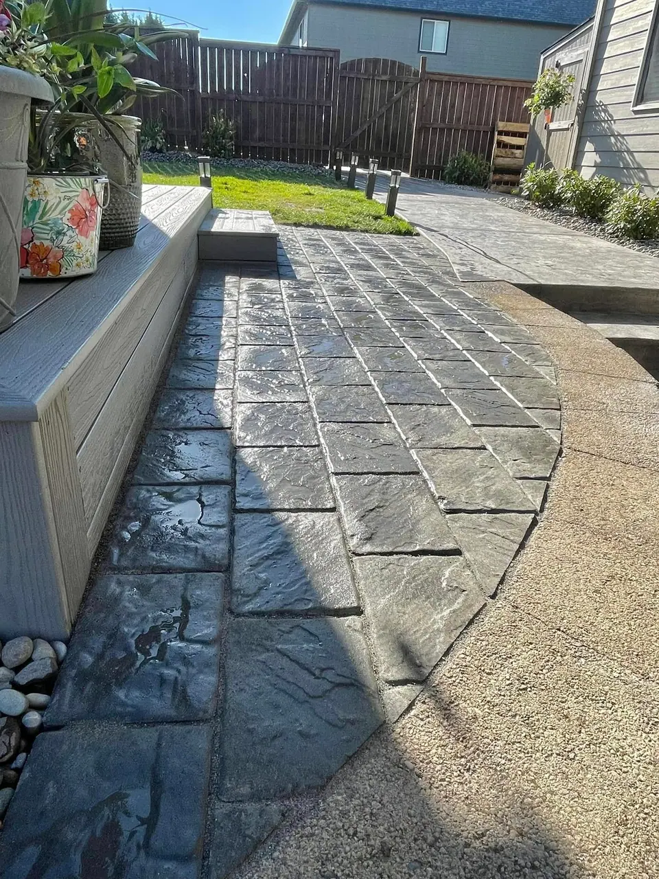 Detail of paver walkway banding against a block wall