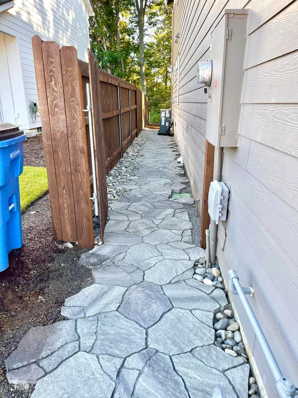 Flagstone path winding through a narrow side yard