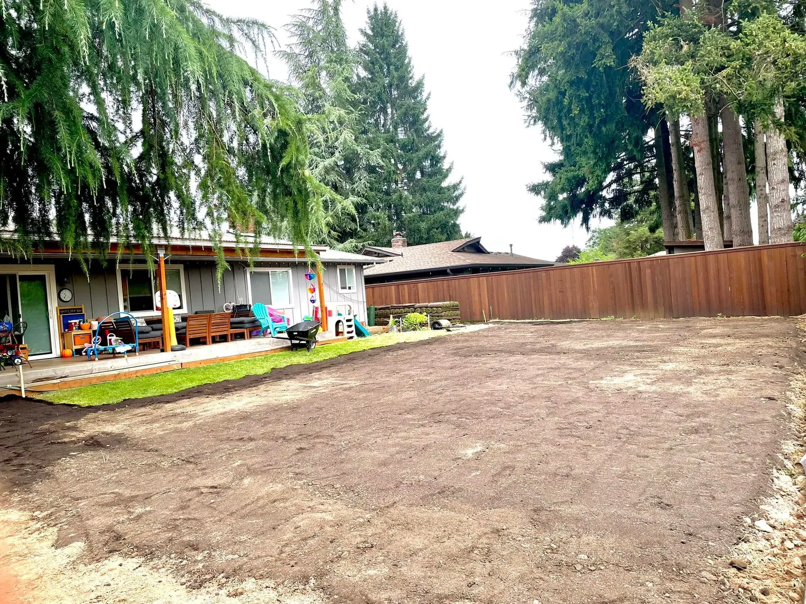 Large gravel parking area finished with a cedar perimeter fence