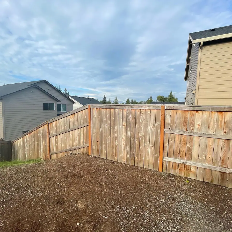 New cedar privacy fence with a fresh bark mulch border