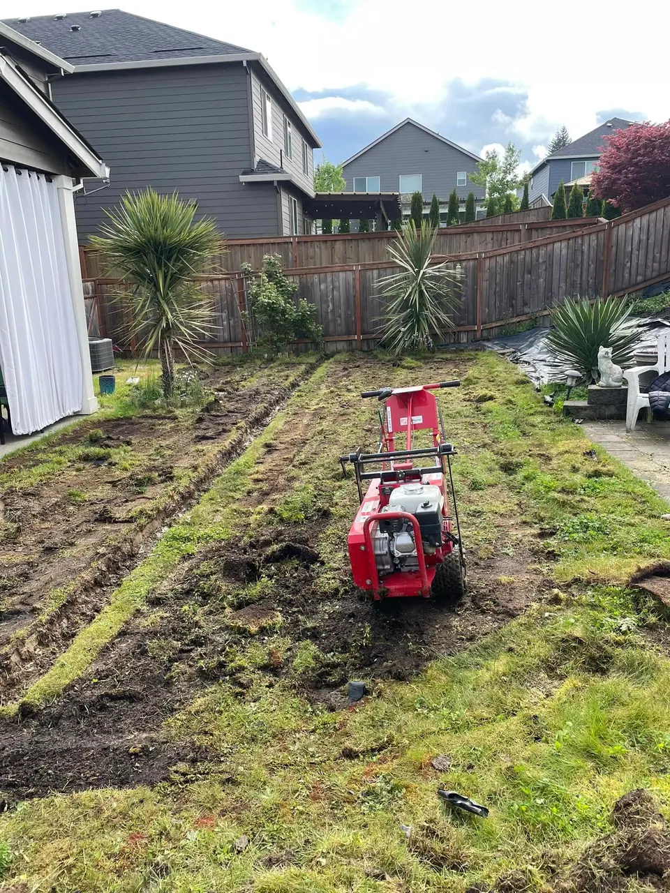 Rototiller preparing compacted soil for a new lawn