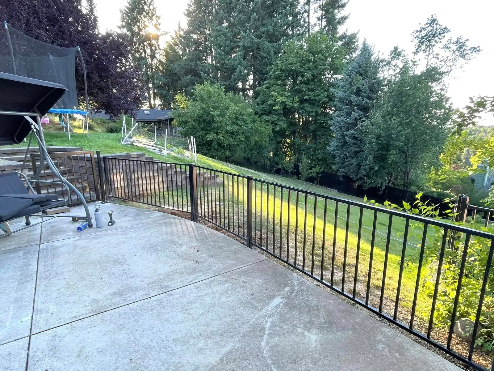 Stamped concrete patio finished with a black iron railing