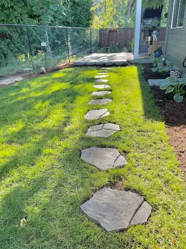 Stepping stone path set into a freshly established lawn